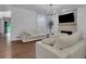 Open living space with white sofas, fireplace, and view to the front entry at 11280 Brookhollow Trl, Alpharetta, GA 30022
