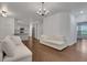 Bright open-plan living area that features hardwood floors and seamlessly connects to the kitchen at 11280 Brookhollow Trl, Alpharetta, GA 30022