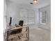Well-lit home office with a large desk, comfortable chair, and bright windows at 11280 Brookhollow Trl, Alpharetta, GA 30022