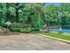 Community playground with swings, a slide, and a tennis court in a green, landscaped area at 11280 Brookhollow Trl, Alpharetta, GA 30022