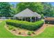 Pool house with a fenced area and a trimmed hedge in a community park setting at 11280 Brookhollow Trl, Alpharetta, GA 30022