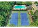 Aerial view of a community pool and tennis courts surrounded by trees at 11280 Brookhollow Trl, Alpharetta, GA 30022