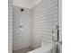Modern bathroom with stylish subway-tiled shower featuring updated fixtures at 11280 Brookhollow Trl, Alpharetta, GA 30022