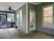 Screened-in porch featuring wood flooring, a ceiling fan, and an exit door at 11280 Brookhollow Trl, Alpharetta, GA 30022