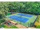 The community offers tennis courts surrounded by mature trees and a playground in the distance at 11280 Brookhollow Trl, Alpharetta, GA 30022