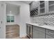 Features gray cabinets with an integrated wine rack and beverage fridge at 11280 Brookhollow Trl, Alpharetta, GA 30022