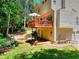 Exterior view of backyard featuring a deck, patio, and mature trees at 1875 Skidmore Cir, Lawrenceville, GA 30044