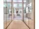 Hallway leading to a bathroom featuring a soaking tub, separate shower, and vanity at 1875 Skidmore Cir, Lawrenceville, GA 30044