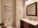 Stylish powder room features a modern vanity with granite countertop and decorative mirror at 1875 Skidmore Cir, Lawrenceville, GA 30044