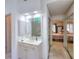 Bright bathroom with vanity and mirror with bedroom access at 1875 Skidmore Cir, Lawrenceville, GA 30044