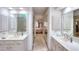 Modern bathroom with dual sinks and vanities, a glass-enclosed shower, and neutral tones at 1875 Skidmore Cir, Lawrenceville, GA 30044