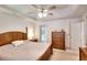 Bright bedroom featuring tray ceilings, a ceiling fan, and lots of natural light at 1875 Skidmore Cir, Lawrenceville, GA 30044