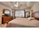 Expansive bedroom featuring tray ceilings, fan, and plenty of room for furniture and relaxation at 1875 Skidmore Cir, Lawrenceville, GA 30044