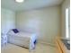 Small bedroom with a twin bed, carpet, and window with shutters at 1875 Skidmore Cir, Lawrenceville, GA 30044