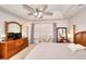 Spacious main bedroom with large window, tray ceiling and ceiling fan at 1875 Skidmore Cir, Lawrenceville, GA 30044