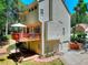 Home exterior showcasing a deck, lush landscaping, and a two-car garage at 1875 Skidmore Cir, Lawrenceville, GA 30044