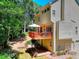Rear exterior of home with a spacious deck and well-maintained landscaping at 1875 Skidmore Cir, Lawrenceville, GA 30044