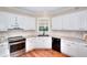 White kitchen featuring stainless steel appliances and granite countertops at 1875 Skidmore Cir, Lawrenceville, GA 30044