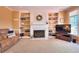 Comfortable living room with built-in shelving and a cozy fireplace at 1875 Skidmore Cir, Lawrenceville, GA 30044