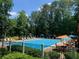 A community pool with plenty of seating and trees around at 1875 Skidmore Cir, Lawrenceville, GA 30044