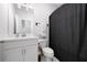 Modern bathroom featuring a vanity with sink, toilet, and a shower with a dark curtain at 3322 Cranston Ln, Kennesaw, GA 30144