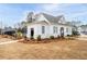 Community building with white siding, a grey roof, landscaping, and outdoor seating for relaxation and gatherings at 3322 Cranston Ln, Kennesaw, GA 30144