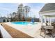 Community pool surrounded by lounge chairs, mature trees, a covered area, and green grass at 3322 Cranston Ln, Kennesaw, GA 30144