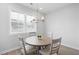 Cozy breakfast nook with round table, seating for four, and natural light from a window at 3322 Cranston Ln, Kennesaw, GA 30144