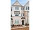 Well-maintained townhome displays a classic light brick and siding facade with black shutters at 3322 Cranston Ln, Kennesaw, GA 30144