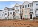 Charming townhomes feature light brick exteriors, complemented by black shutters and a decorative iron fence at 3322 Cranston Ln, Kennesaw, GA 30144