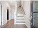 Inviting foyer features hardwood floors, a staircase, and views to a bright living space at 3322 Cranston Ln, Kennesaw, GA 30144