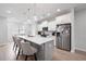 Bright kitchen boasts an island with seating, modern appliances, and pendant lighting at 3322 Cranston Ln, Kennesaw, GA 30144