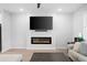 Living area featuring a modern fireplace, wall-mounted TV, and neutral decor at 3322 Cranston Ln, Kennesaw, GA 30144