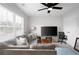 Cozy living room with a large window, comfortable seating, ceiling fan, and a television for relaxation at 3322 Cranston Ln, Kennesaw, GA 30144