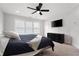 Comfortable bedroom with a ceiling fan, TV, and dresser at 3322 Cranston Ln, Kennesaw, GA 30144