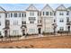 Charming townhomes feature light brick exteriors, complemented by black shutters and a decorative iron fence at 3322 Cranston Ln, Kennesaw, GA 30144