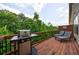 Relaxing outdoor deck with wooded views, grill, and comfortable lounge chairs at 4104 Townsend Ln, Dunwoody, GA 30346