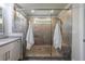 Modern bathroom featuring glass shower with gray tiling, shower bench, and a double shower head at 4104 Townsend Ln, Dunwoody, GA 30346