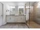 Modern bathroom with double vanity, quartz countertop, and tiled glass enclosed shower at 4104 Townsend Ln, Dunwoody, GA 30346