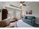Bonus room with a couch, a striped chair, two windows and recessed lights in the tray ceiling at 4104 Townsend Ln, Dunwoody, GA 30346