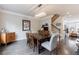 Bright dining room featuring a modern light fixture, wood table, and stairs to the second floor at 4104 Townsend Ln, Dunwoody, GA 30346