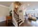 Welcoming entryway with hardwood floors, staircase, and seamless flow into the living room at 4104 Townsend Ln, Dunwoody, GA 30346