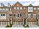 Beautiful brick and stone townhome with well-maintained landscaping and attached garages at 4104 Townsend Ln, Dunwoody, GA 30346