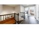 Upstairs hallway featuring wood floors, wrought iron railing and views into the bedrooms at 4104 Townsend Ln, Dunwoody, GA 30346