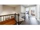 Hallway with hardwood floors leading to an open concept bedroom, sitting area, and staircase at 4104 Townsend Ln, Dunwoody, GA 30346
