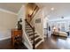 Hallway with dark wood floors, staircase with wrought iron railing, leading to an open living area at 4104 Townsend Ln, Dunwoody, GA 30346