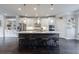 Spacious kitchen features an island with bar stool seating, stainless appliances, and elegant pendant lighting at 4104 Townsend Ln, Dunwoody, GA 30346