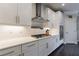 Updated kitchen with white cabinets, stainless steel range hood, and gas cooktop at 4104 Townsend Ln, Dunwoody, GA 30346