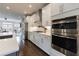 A bright, open kitchen features white cabinets, modern appliances, and hardwood floors at 4104 Townsend Ln, Dunwoody, GA 30346