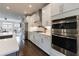 Open concept kitchen featuring modern appliances, white cabinets, and view to the living area at 4104 Townsend Ln, Dunwoody, GA 30346